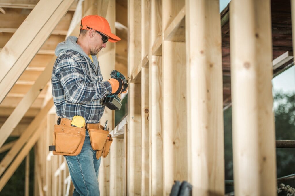 Contractor with Power Screwdriver on the Contraction Site