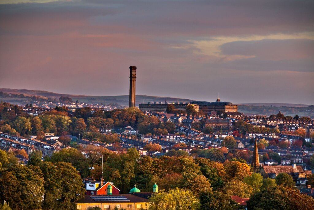 Aerial shot of an old mill in the city of Bradford under the gloomy clouds in Yorkshire, England