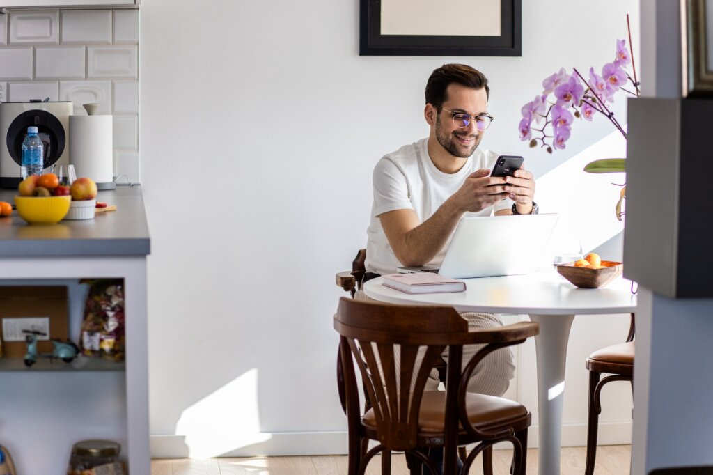 Man working at home using laptop.