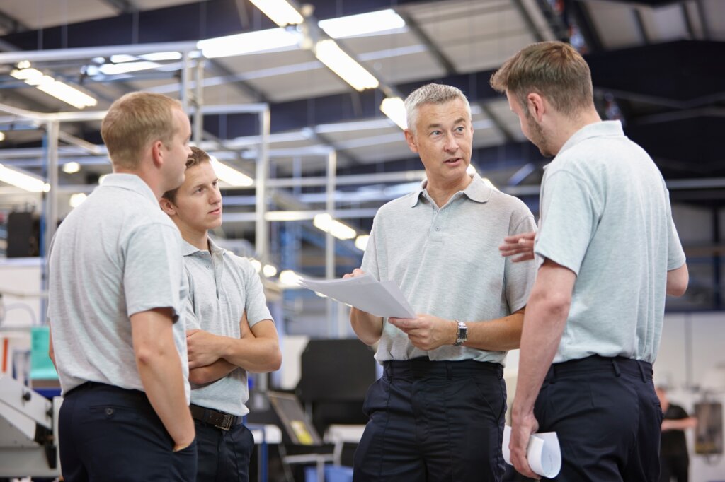 Workers meeting in engineering factory