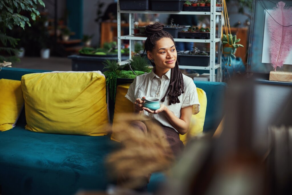 ovely young florist daydreaming during the coffee break